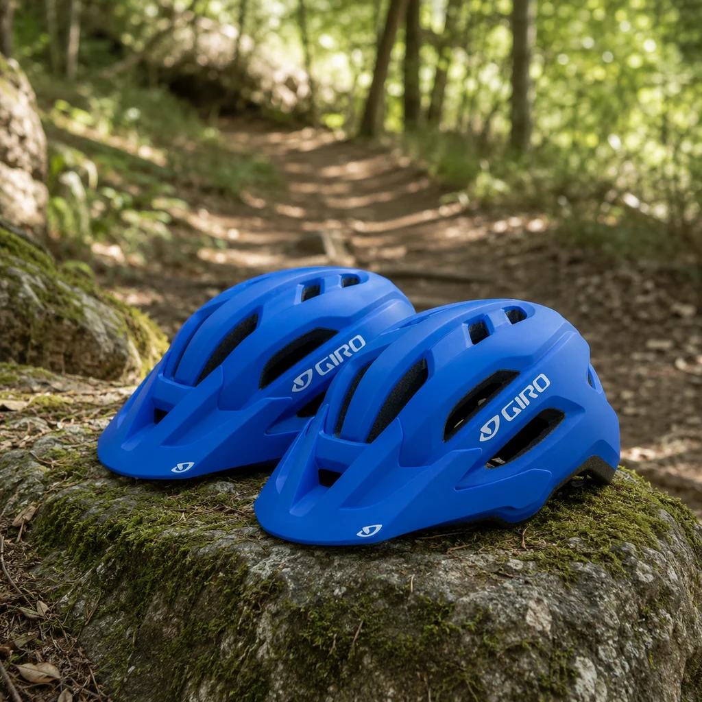 Giro Fixture II MIPS helmet on a mossy rock beside a dirt singletrack trail