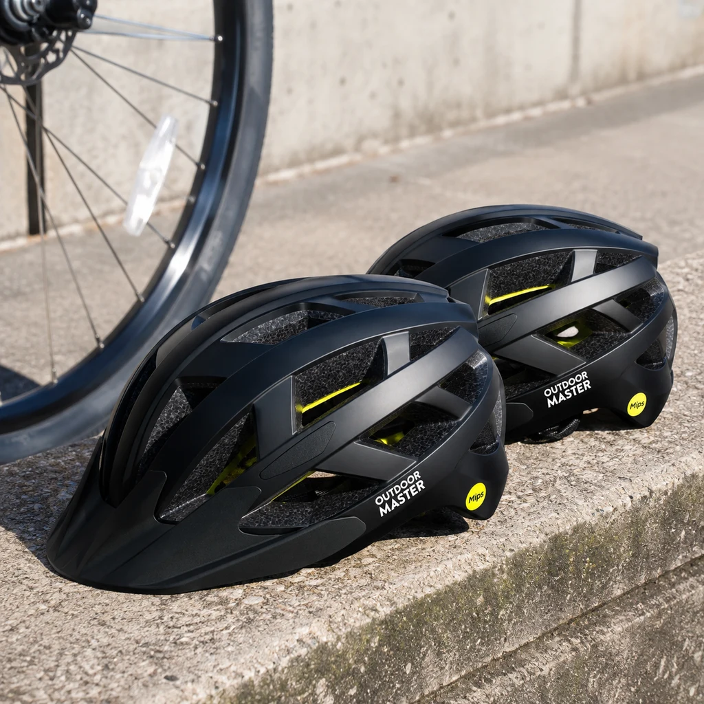 OutdoorMaster Gem MIPS helmet on a concrete ledge beside a commuter bike wheel