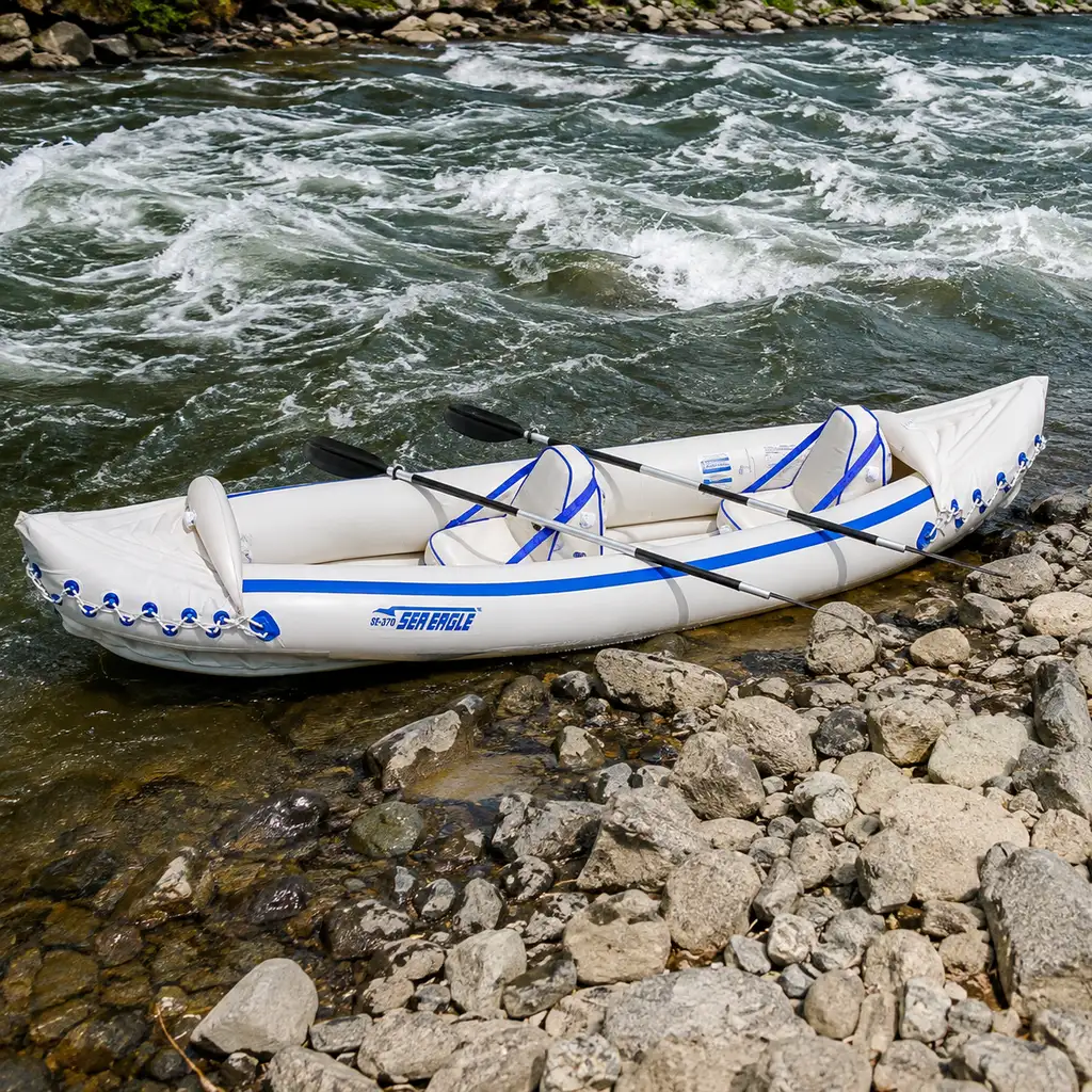 Sea Eagle 370 Pro inflatable kayak on moving river water by a rocky bank