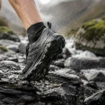 The best trail running shoes gripping wet rock beside a mountain stream