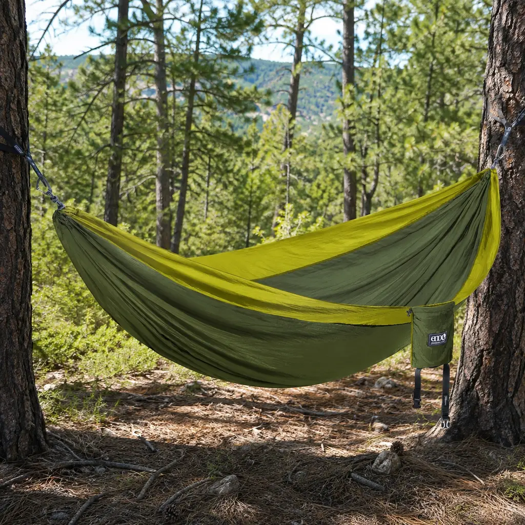 ENO DoubleNest hammock hung between pine trees in a sunlit clearing