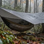 Hammock under a taut grey hex tarp in steady rain in the Smokies
