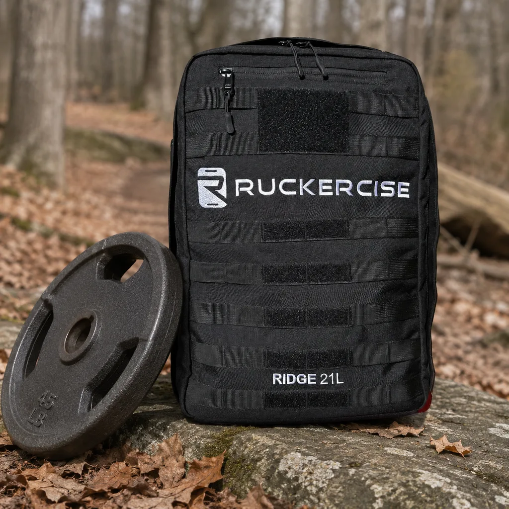 Ruckercise Ridge 21L rucksack on a rock with a cast iron weight plate beside it