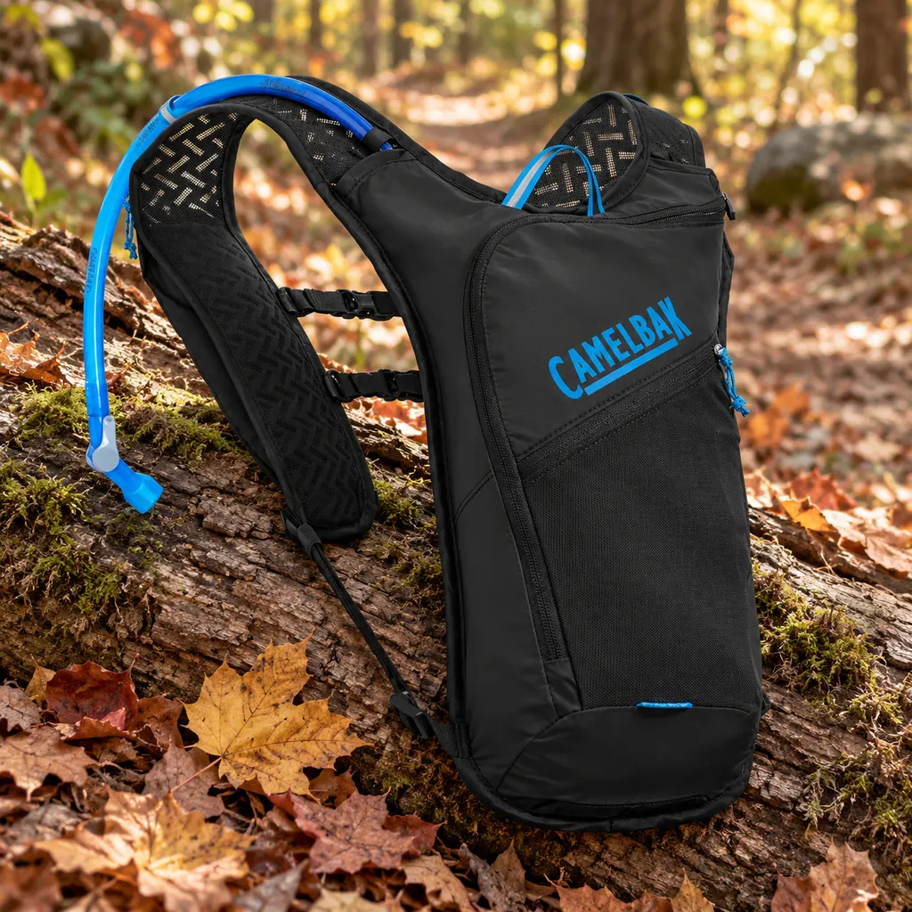 CamelBak Dart minimalist run vest laid over a log on a leaf covered trail