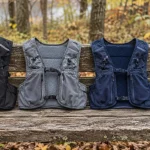 The best trail running vests laid out on a bench with soft flasks and a wind shell