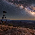 Carbon tripod and camera on slickrock under the Milky Way in Canyonlands