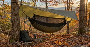 Complete hammock camp with bug net, underquilt and tarp in a North Carolina fall forest